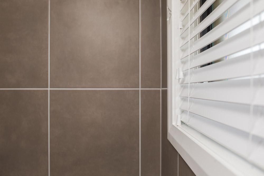 A Close Up Of A Window With Blinds On It — Wares Blinds, Screens & Awnings In Gladstone Central, QLD