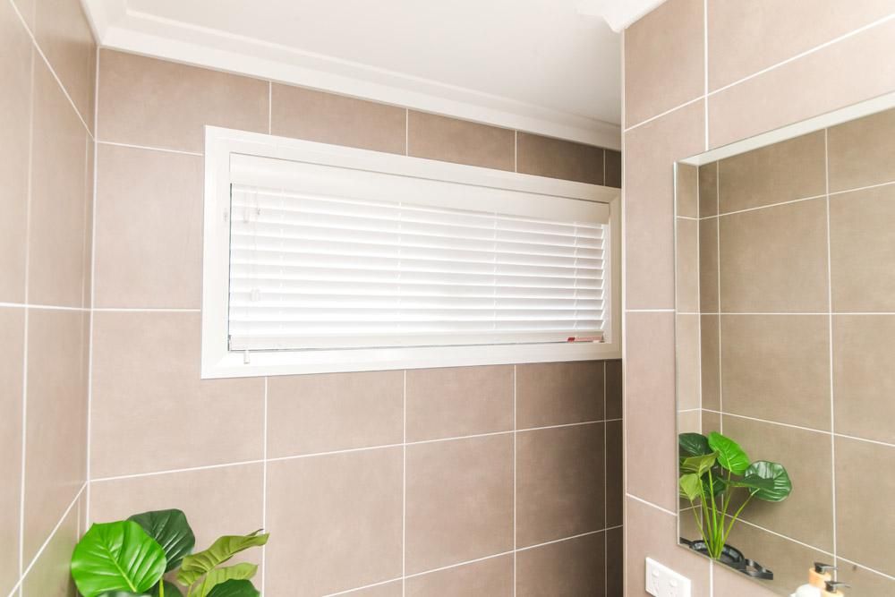 A Bathroom With A Window And A Mirror — Wares Blinds, Screens & Awnings In Gladstone Central, QLD