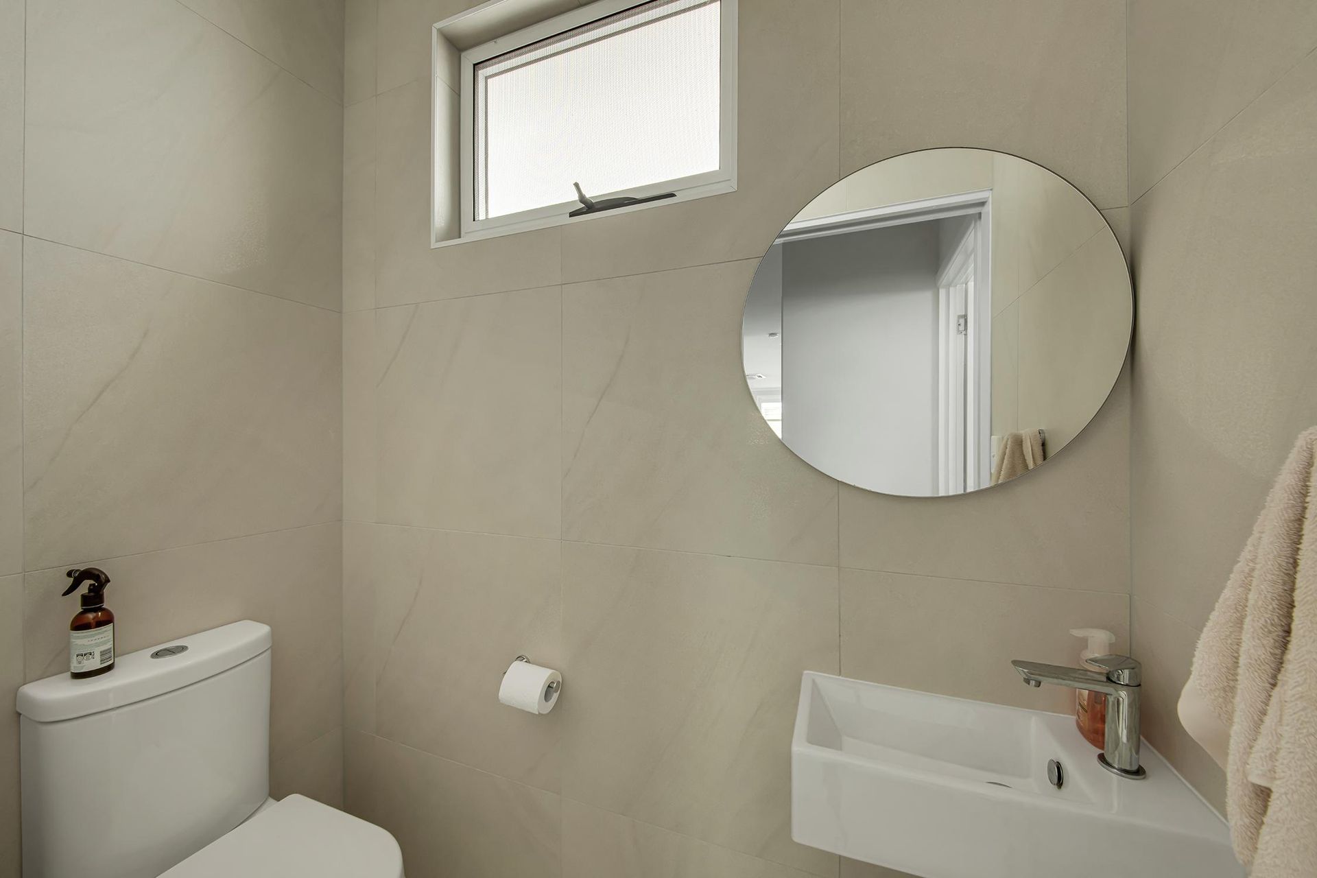 A Bathroom With A Toilet , Sink And Mirror — Wares Blinds, Screens & Awnings In Gladstone Central, QLD