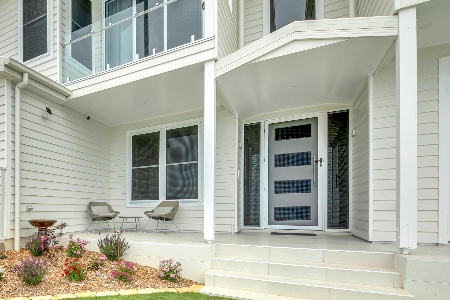A White House With A Porch And Stairs Leading To The Front Door — Wares Blinds, Screens & Awnings In Gladstone Central, QLD
