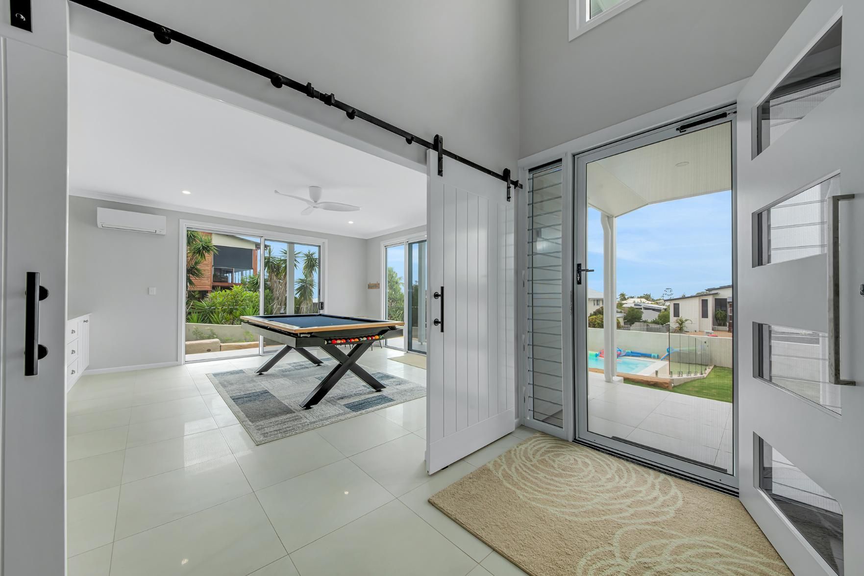There Is A Pool Table In The Middle Of The Room And A Security Door — Wares Blinds, Screens & Awnings In Gladstone Central, QLD