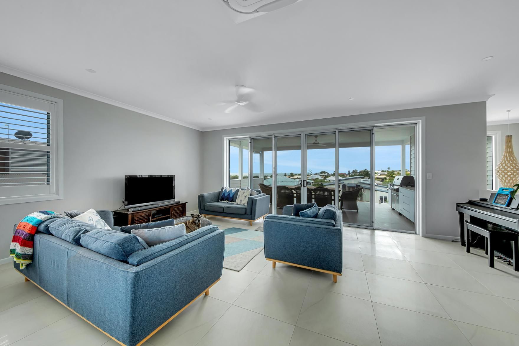 A Living Room Filled With Furniture And A Piano — Wares Blinds, Screens & Awnings In Gladstone Central, QLD