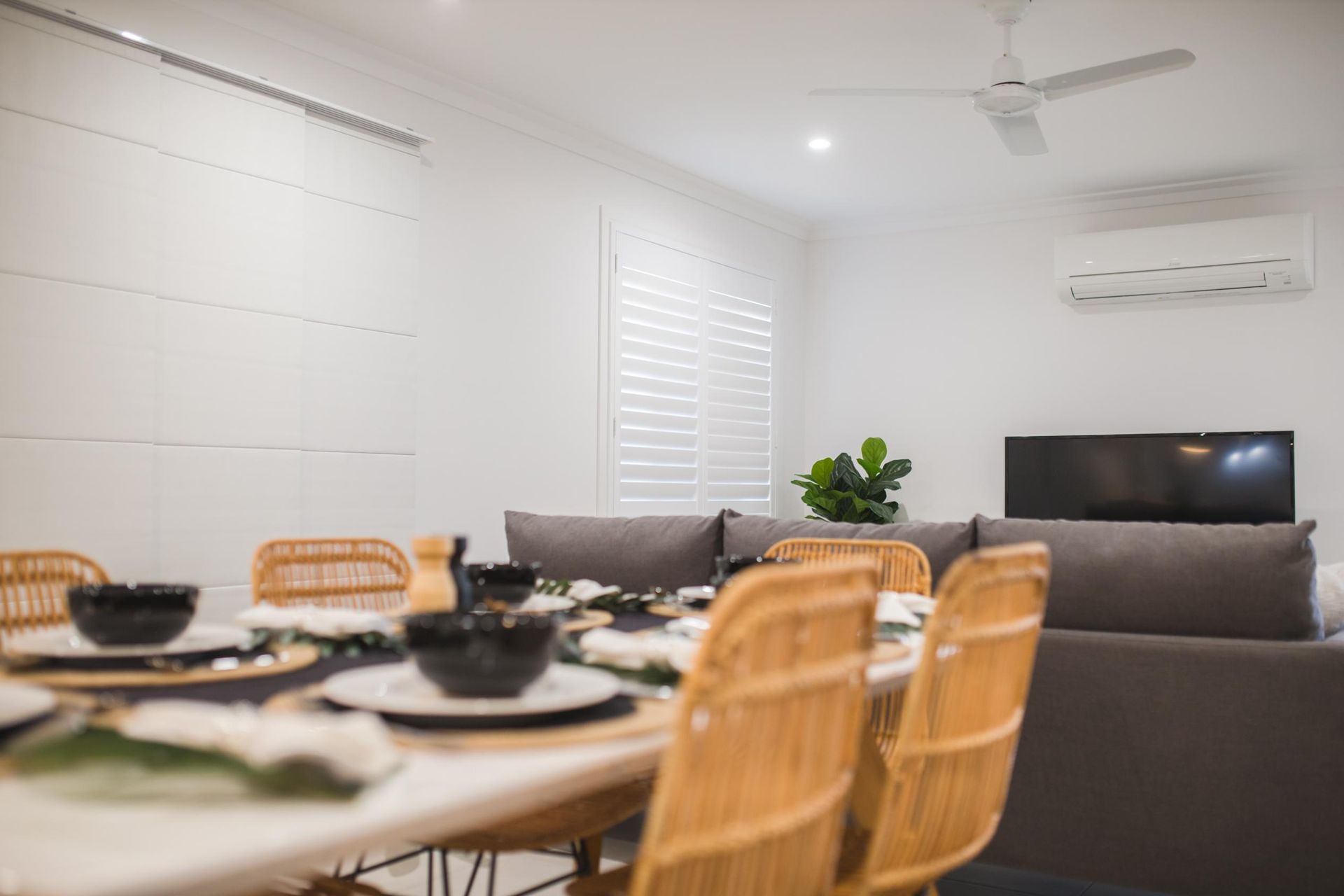 A Living Room With A Dining Table And Chairs And A Ceiling Fan — Wares Blinds, Screens & Awnings In Gladstone Central, QLD