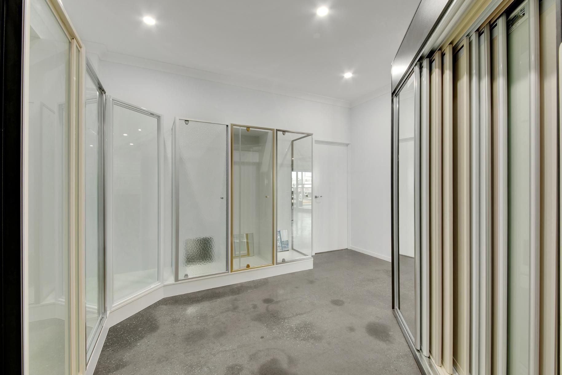 A Room With A Lot Of Glass Doors And A Carpeted Floor — Wares Blinds, Screens & Awnings In Gladstone Central, QLD