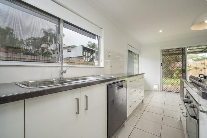 A Kitchen With White Cabinets — Wares Blinds, Screens & Awnings In Gladstone Central, QLD