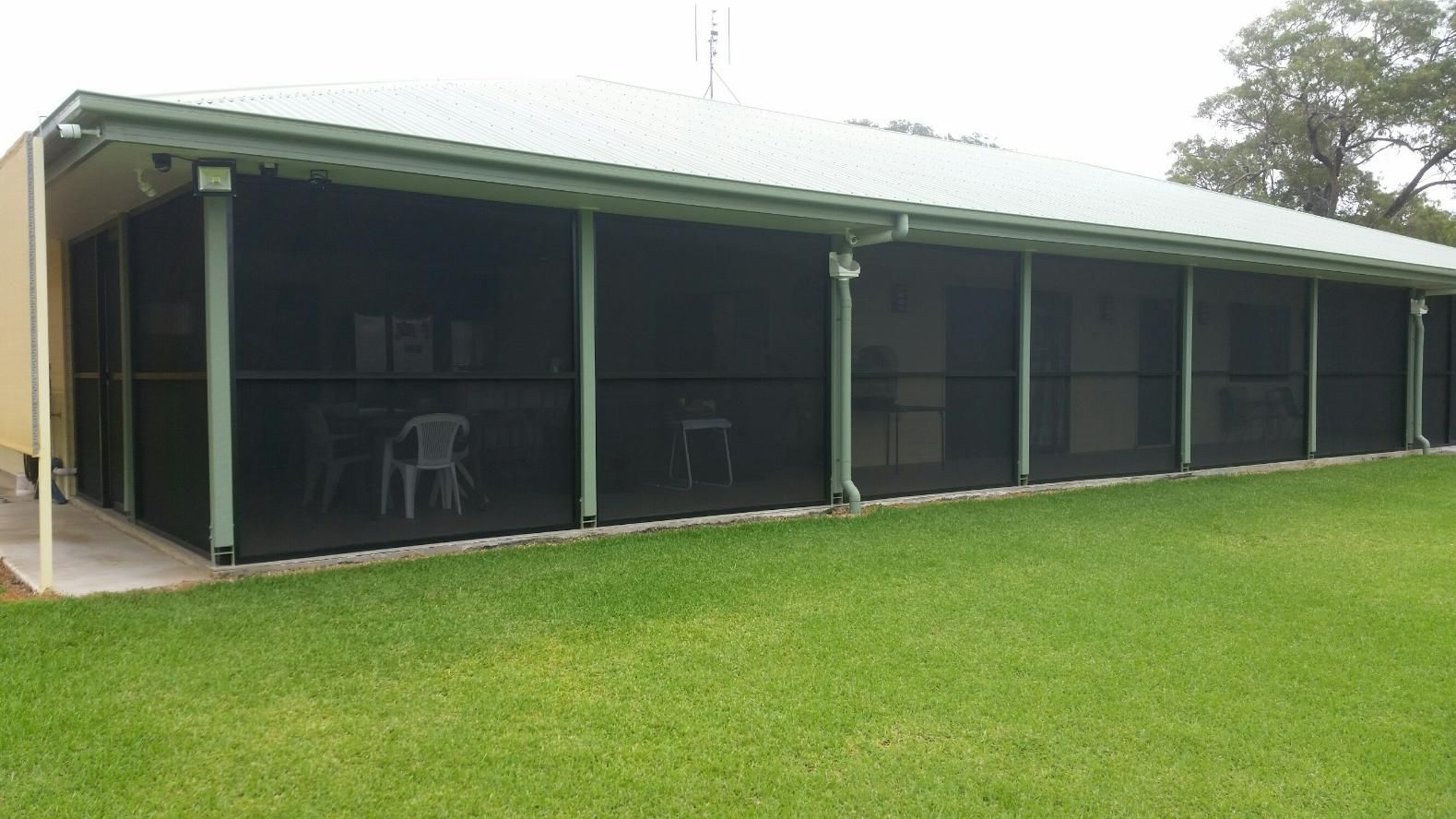 A House With A Screened In Porch And A Lawn In Front Of It  — Wares Blinds, Screens & Awnings In Gladstone Central, QLD