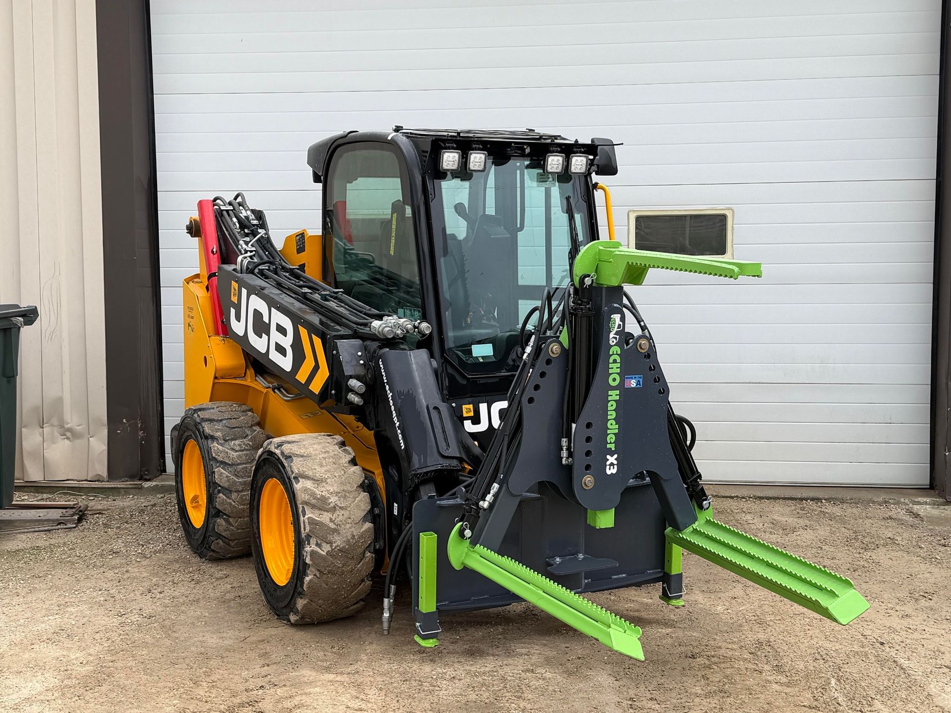 ECHO X3 skid steer tire handler mounted on JCB for lifting and positioning large tractor and equipment tires