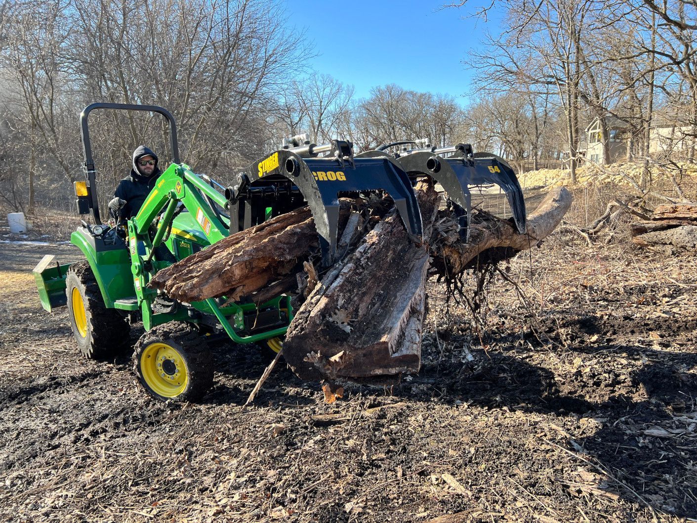 Stinger CROG compact tractor rock grapple attachment mounted on John Deere tractor loader