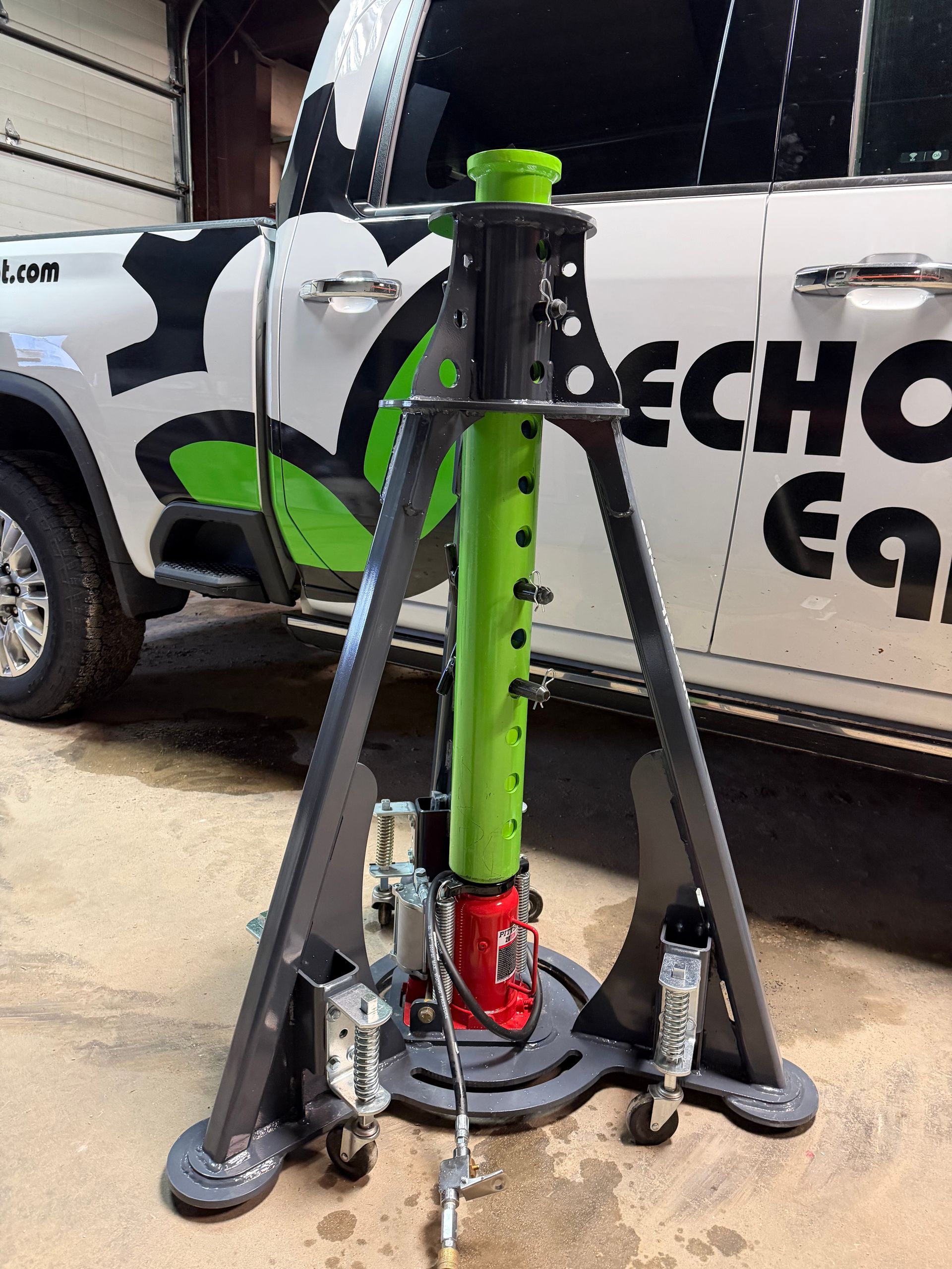 ECHO 20 ton pneumatic sprayer jack lifting rear section of large agricultural sprayer