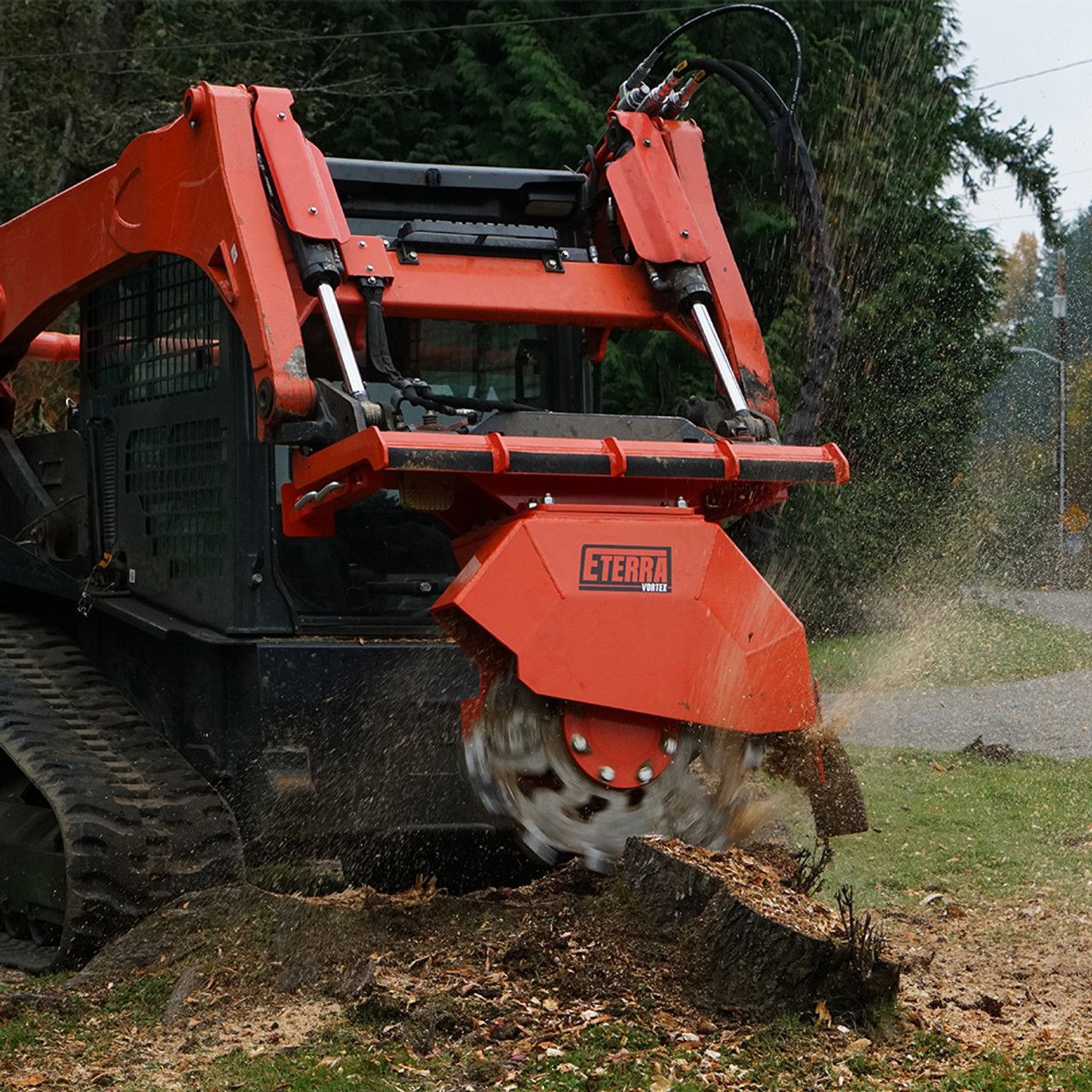 Eterra Vortex skid steer stump grinder attachment mounted on skid steer cutting tree stump during land clearing operation