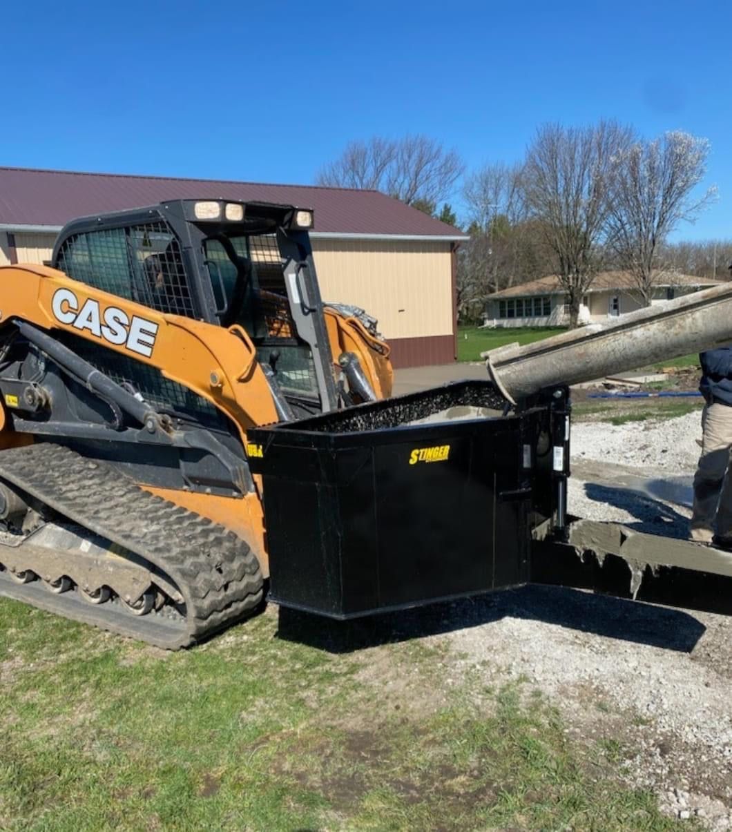 Case skid steer operating Stinger CB75 concrete bucket pouring concrete