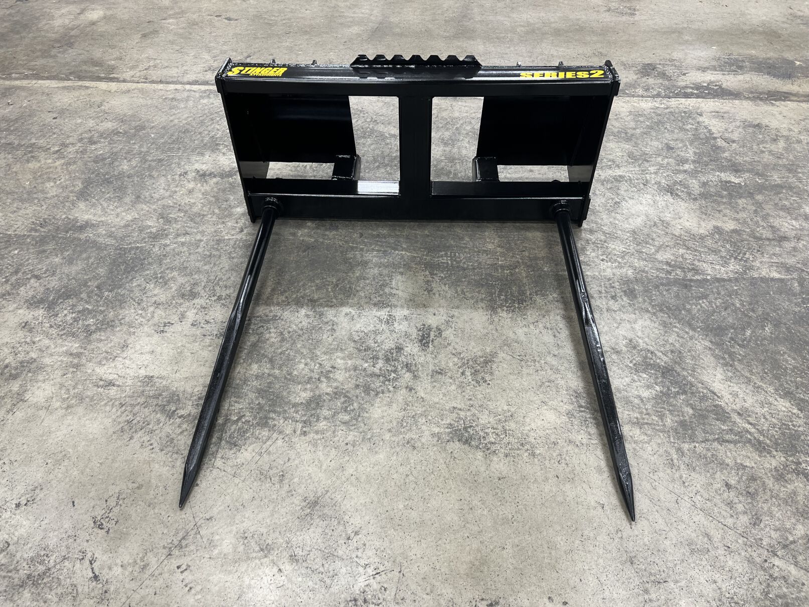 Stinger BS3 skid steer bale spear angled view showing spear length and frame design for round bale transport