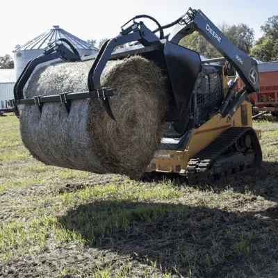 Prime Attachments high capacity skid steer grapple handling round hay bale with dual grapple arms