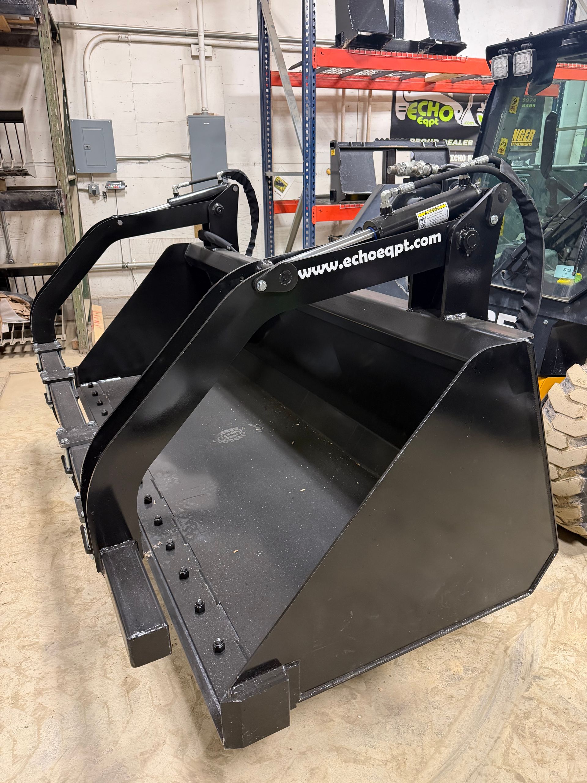 Prime Attachments high capacity skid steer grapple handling round hay bale with dual grapple arms
