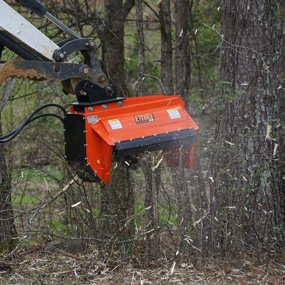 Eterra EX-30 excavator flail mower mounted on excavator showing brush cutting capability and boom arm reach