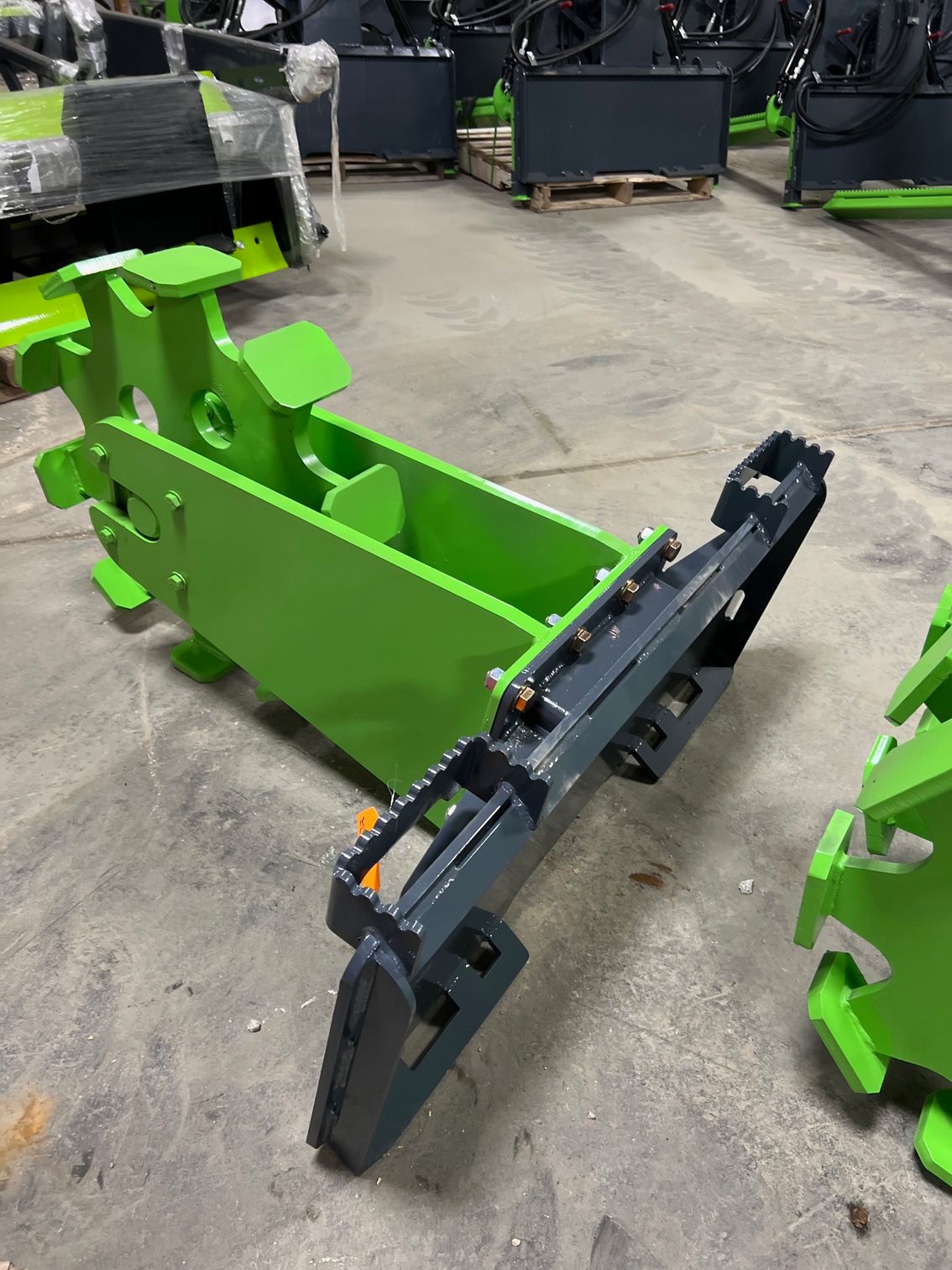ECHO SSCW skid steer single compaction wheel attachment mounted on skid steer inside shop for trench soil compaction