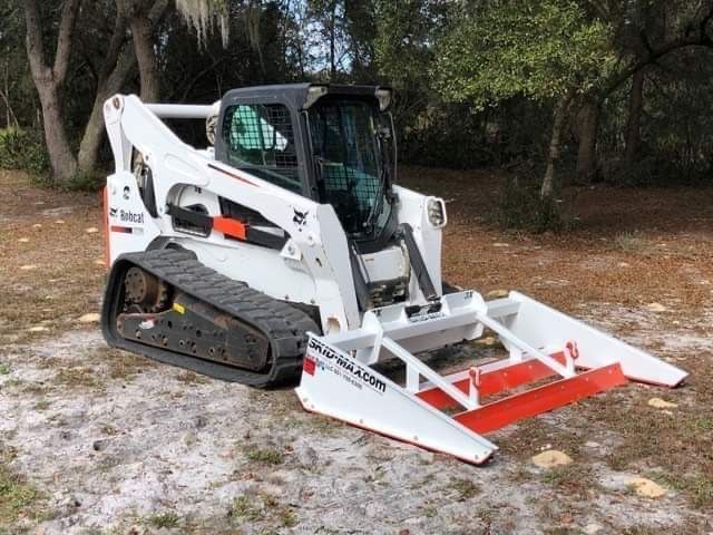 Skid-Max 3X skid steer dirt and gravel grader mounted on Bobcat showing precision grading capability for driveways and lots