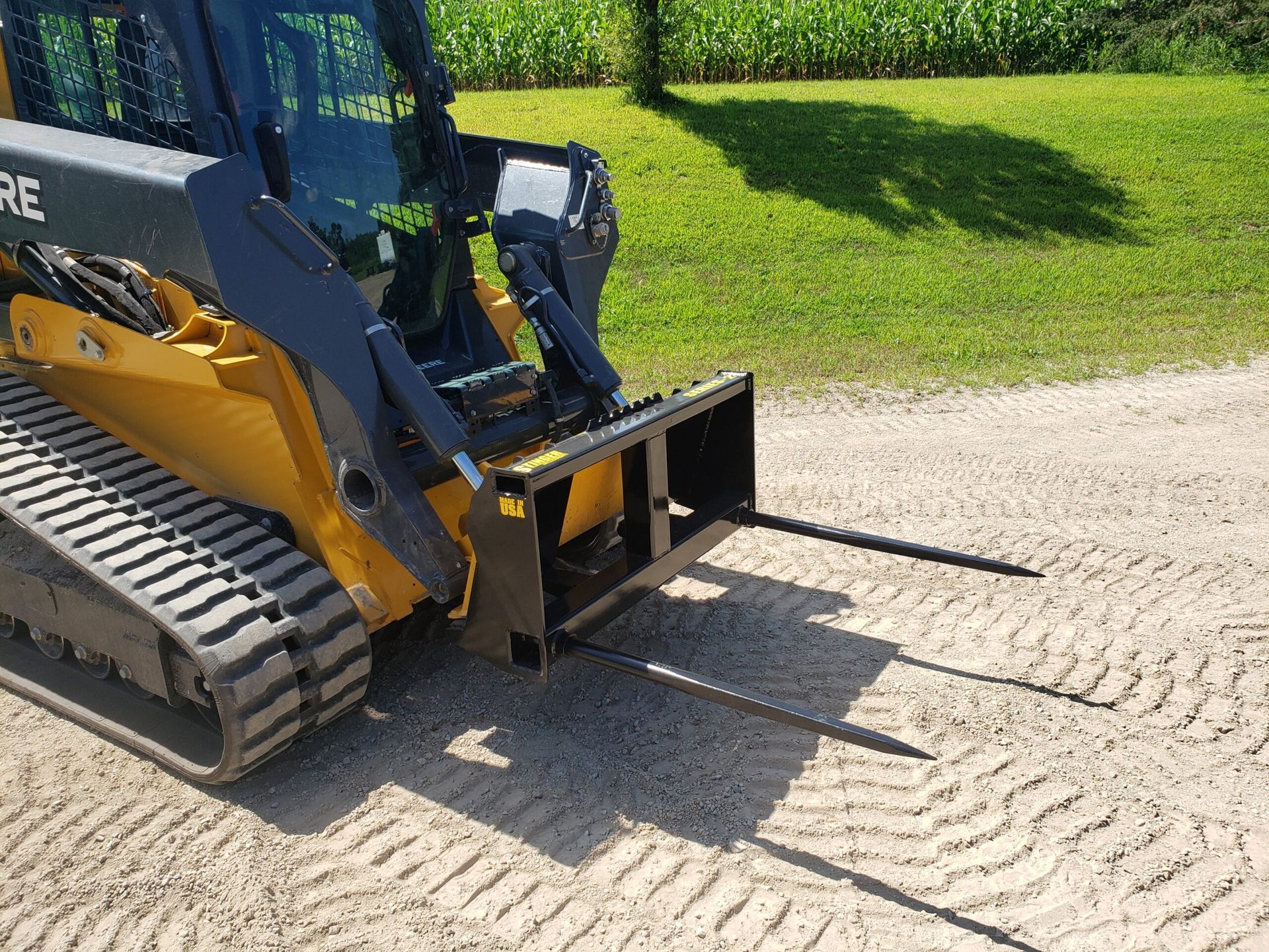 Stinger BS3 skid steer bale spear angled view showing spear length and frame design for round bale transport