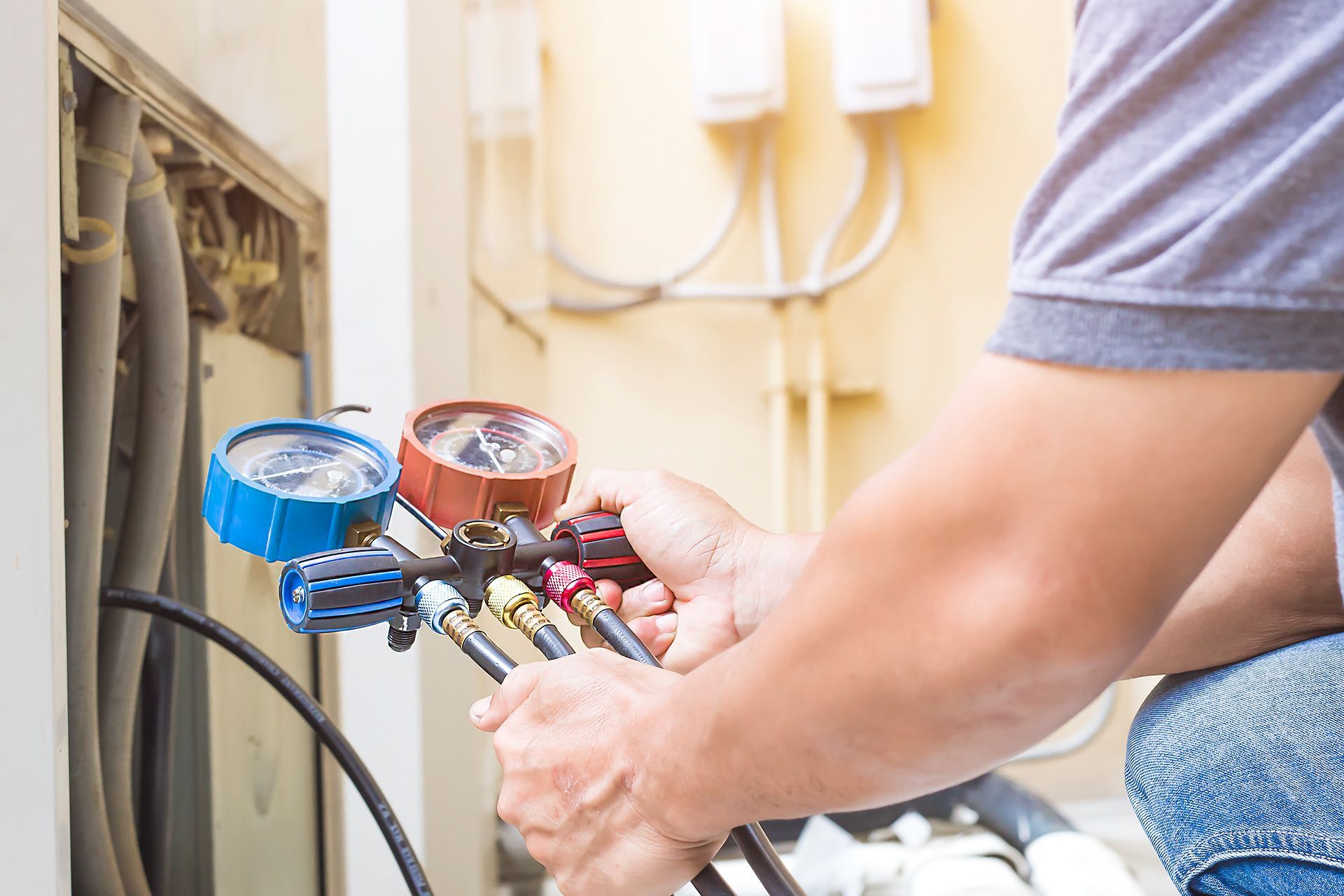 HVAC technician performing air conditioner tune-up service