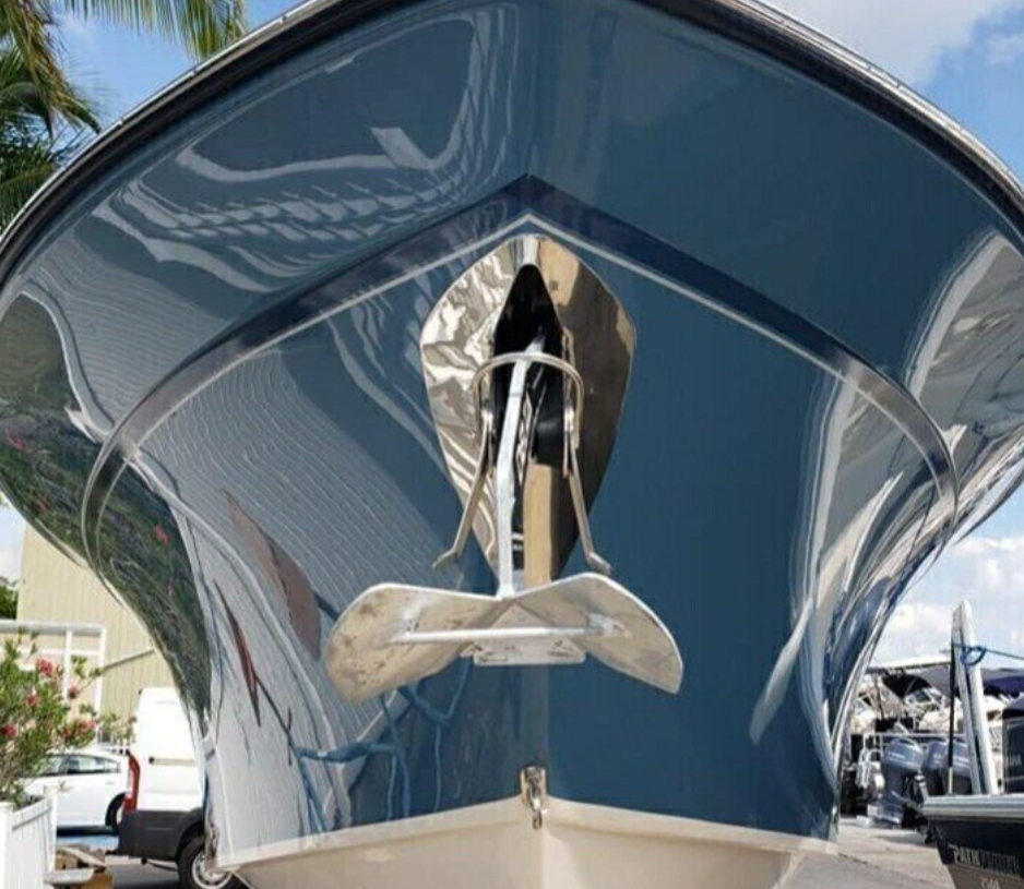 Blue boat bow with shiny anchor.