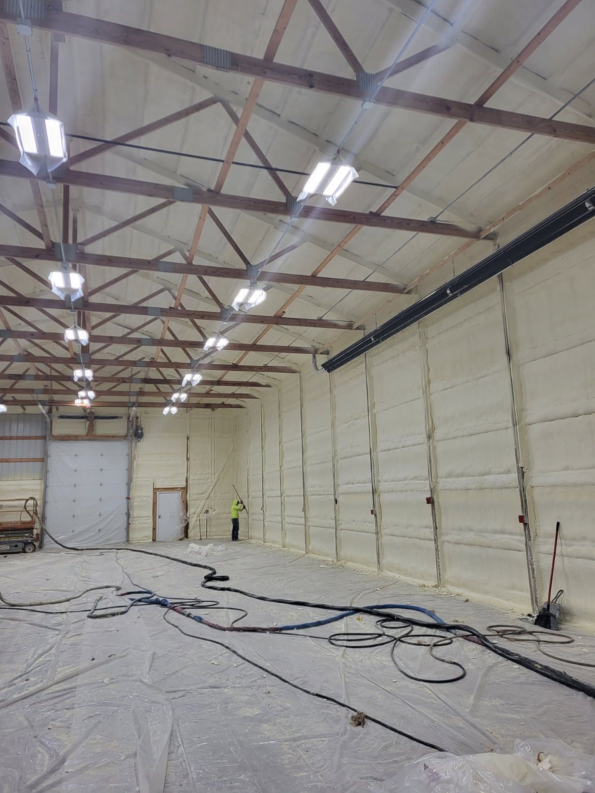 A large warehouse with a lot of wires hanging from the ceiling.