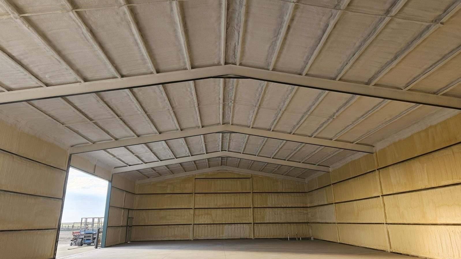 A large warehouse with a roof that is covered in insulation.