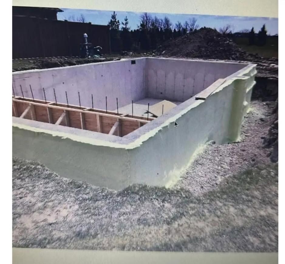 A large white swimming pool is being built in the dirt.