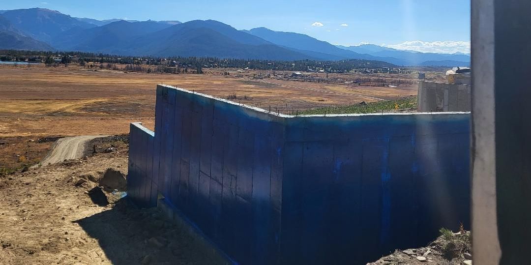 A man is standing on a lift in a warehouse.