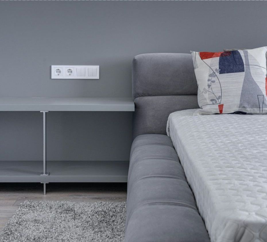 A bedroom with a bed and a nightstand