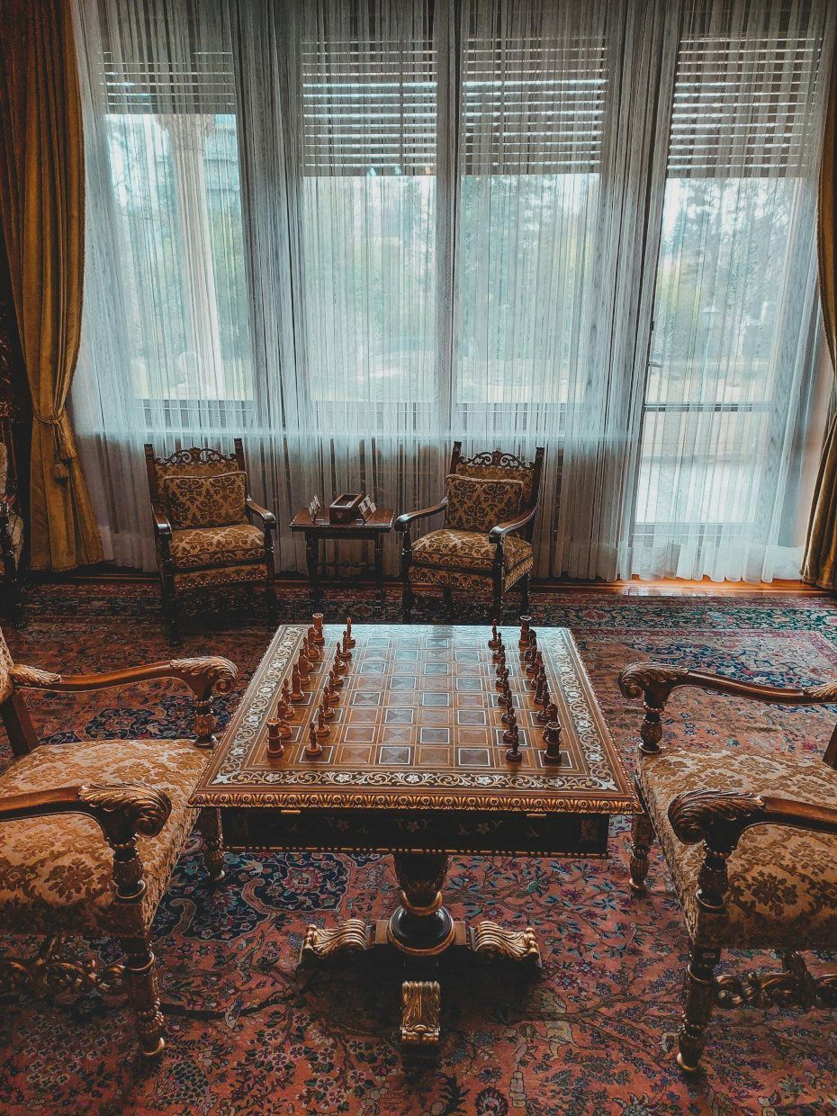 There is a chess board on the table in the middle of the room.