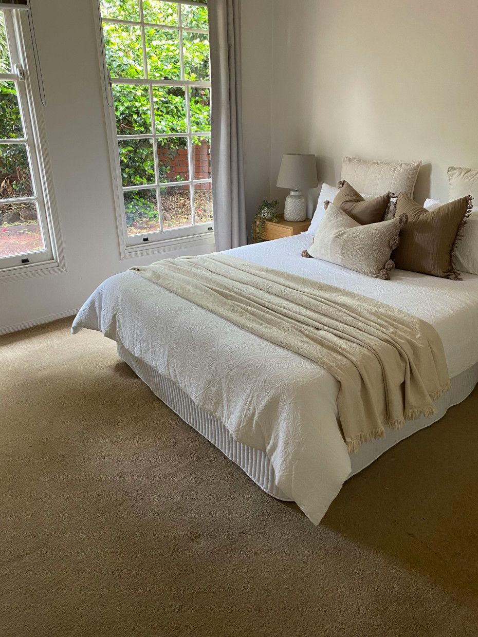 A bedroom with a large bed and a window.
