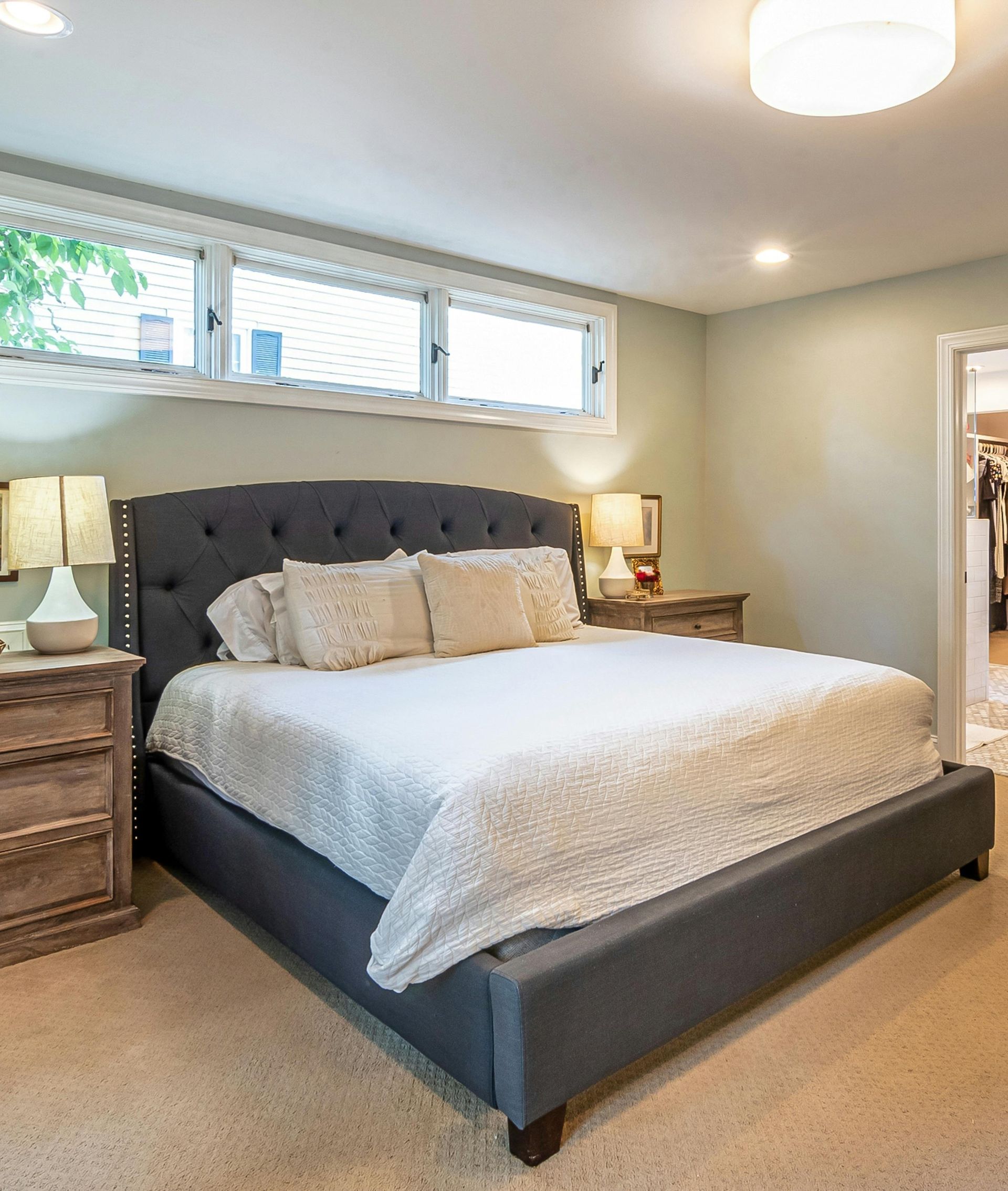 A bedroom with a large bed and two nightstands