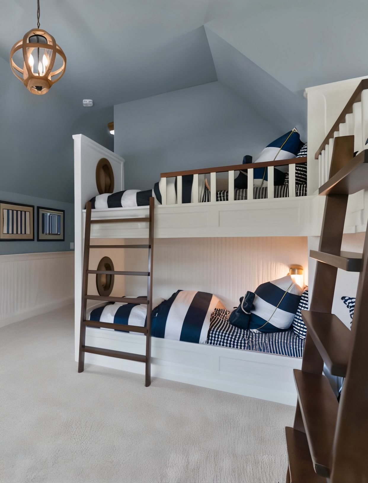 Bunk beds in a nautical-themed room with blue and white striped bedding. Wooden ladders lead to the top bunk.
