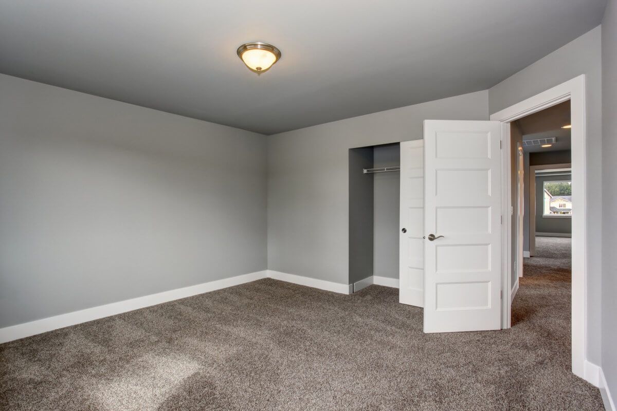 Empty room with freshly installed carpet in a Denton family home by Foxglove Flooring carpet fitters.