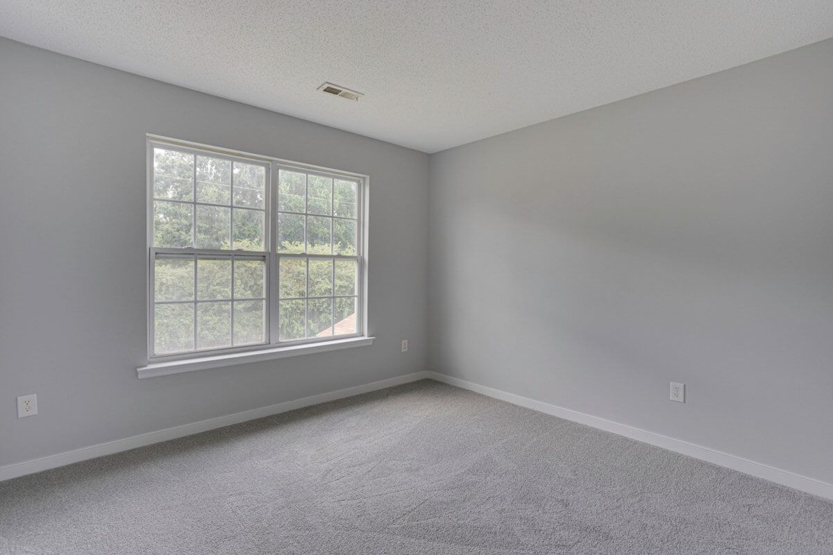 Empty room in a Kenton home prepared for professional carpet installation by Foxglove Flooring carpet fitters.