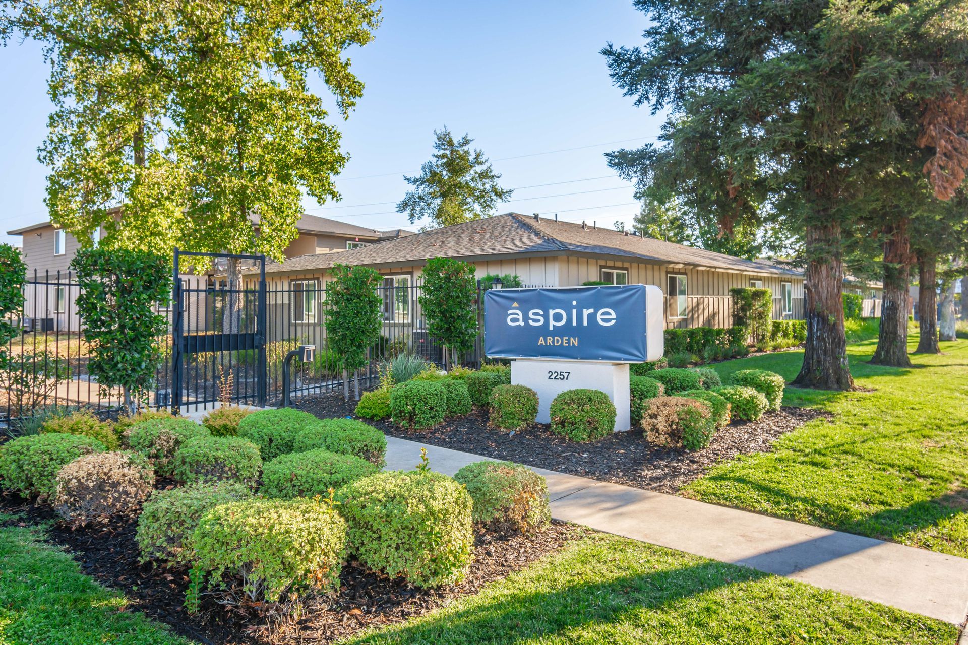 A building with a sign in front of it that says aspire