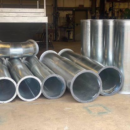 A bunch of metal pipes are stacked on top of each other.