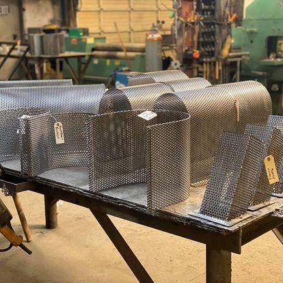 A table with a bunch of metal boxes on it