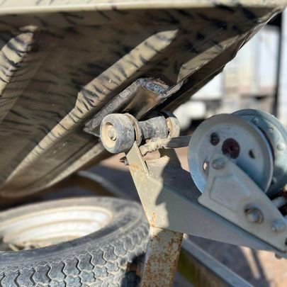 A close up of a wheel on a trailer with a tire.