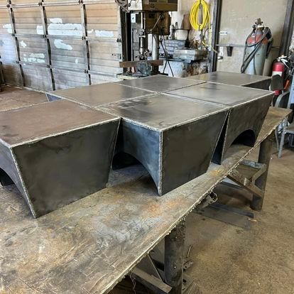 A bunch of metal blocks are sitting on top of a wooden table.