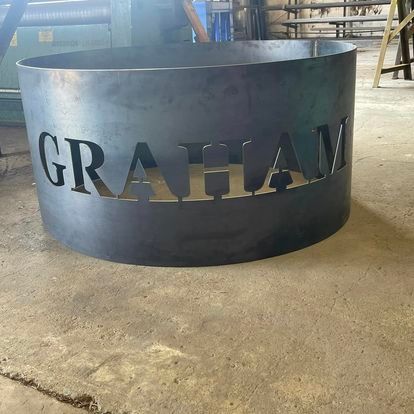 A metal cylinder with the name graham cut out of it.