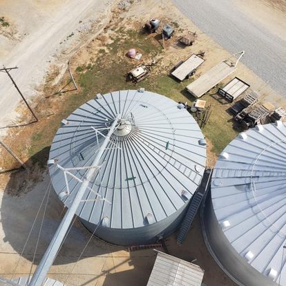 An aerial view of a grain silo with stairs leading up to it