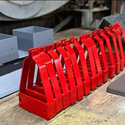 A bunch of red objects are sitting on a wooden table