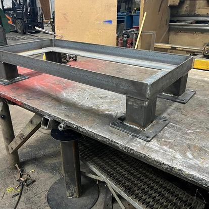 A metal frame is sitting on top of a wooden table.