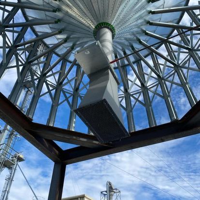 Looking up at a metal structure with a blue sky in the background