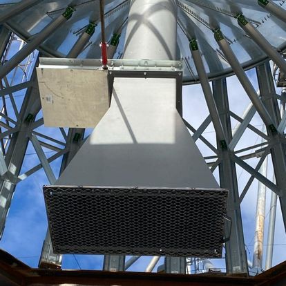 Looking up at a metal structure with a blue sky in the background