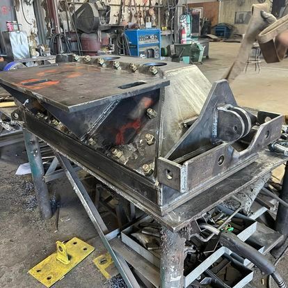 A piece of metal is sitting on top of a table in a workshop.