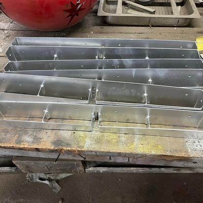 A bunch of metal boxes are sitting on top of a wooden table.