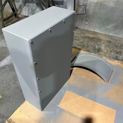 A gray box is sitting on top of a wooden table.