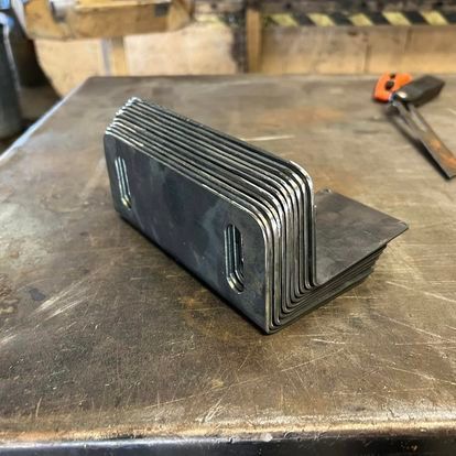 A bunch of metal pieces are stacked on top of each other on a table.